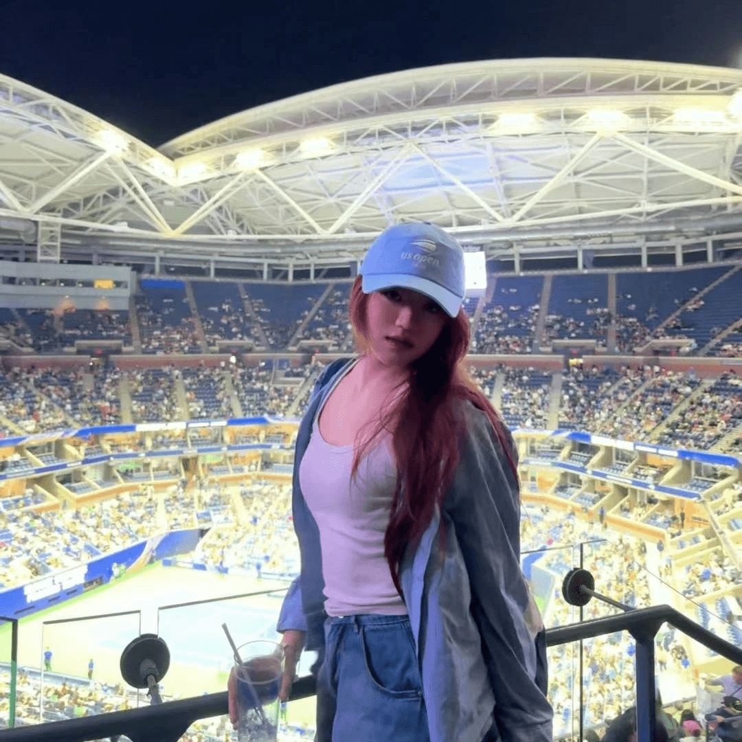 Rebecca at a tennis stadium at night